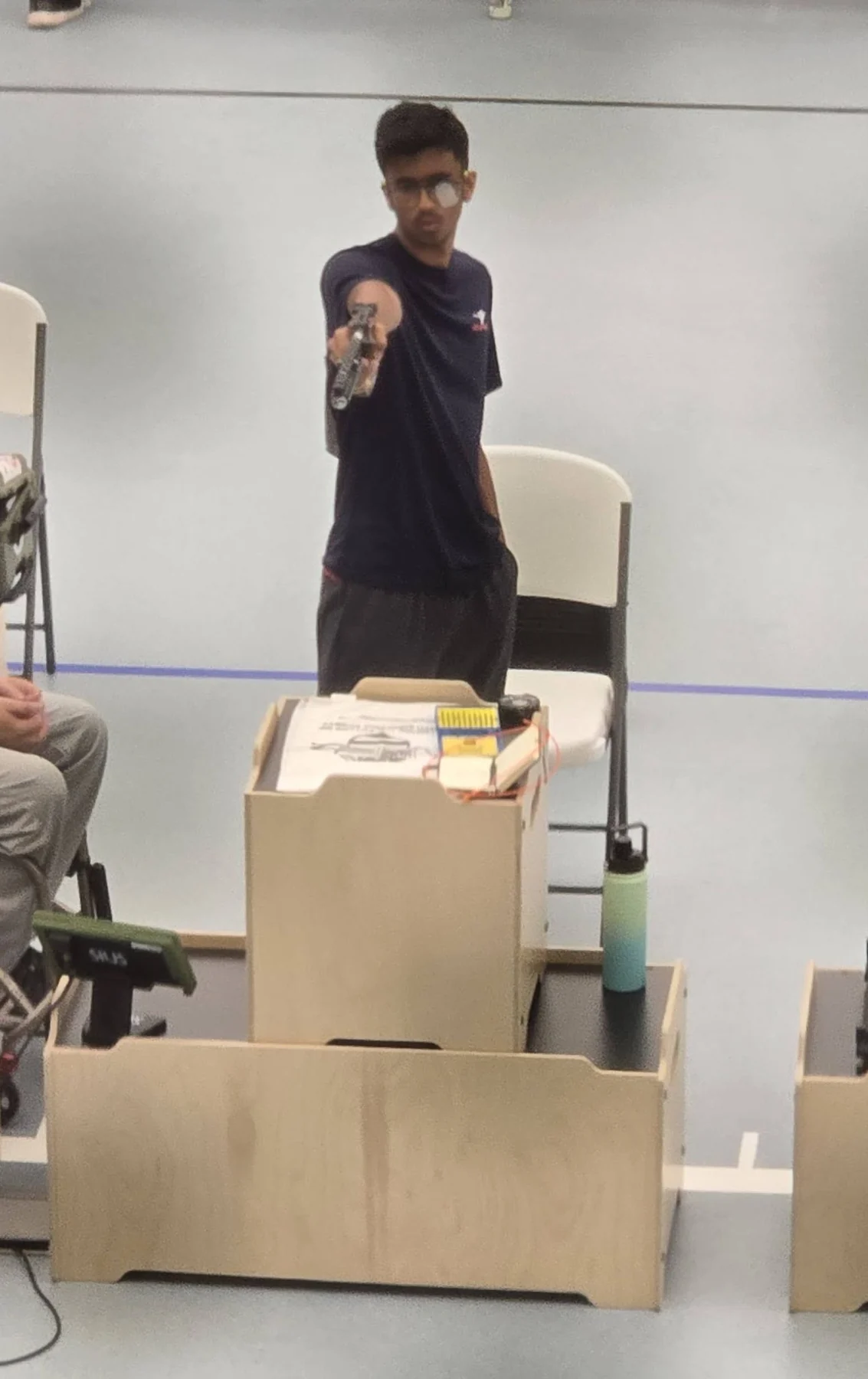 Precision pistol athletes competing on an electronic-target line